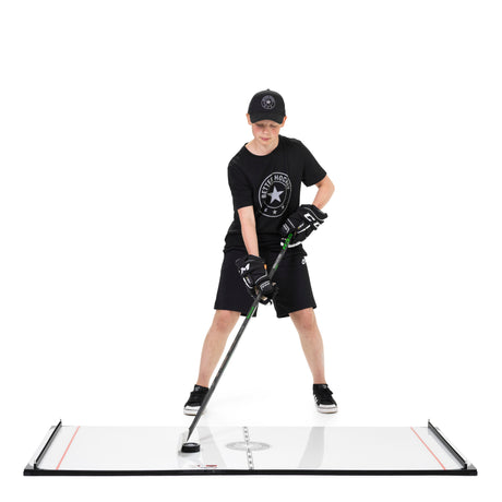 Young hockey player stickhandling on a Better Hockey Game Changer training board in ready position
