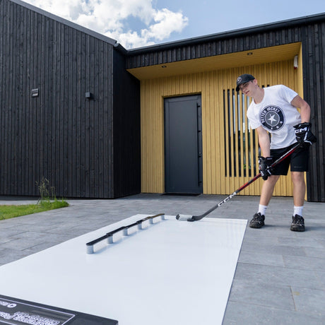 Hockey player running pre-game stickhandling routine on a shooting pad outside